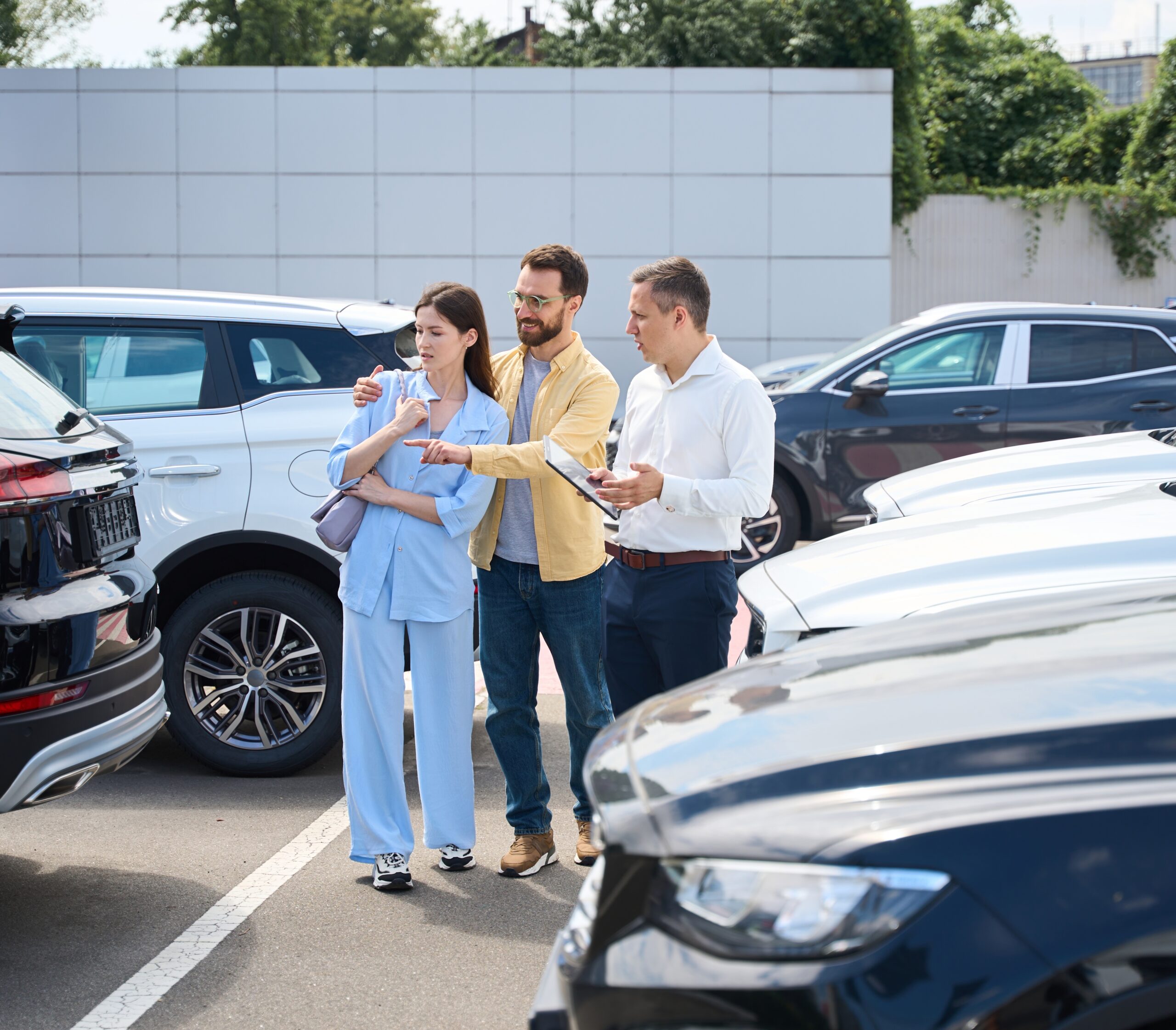 Husband,And,Wife,Choose,Car,In,Yard,Of,Car,Dealership